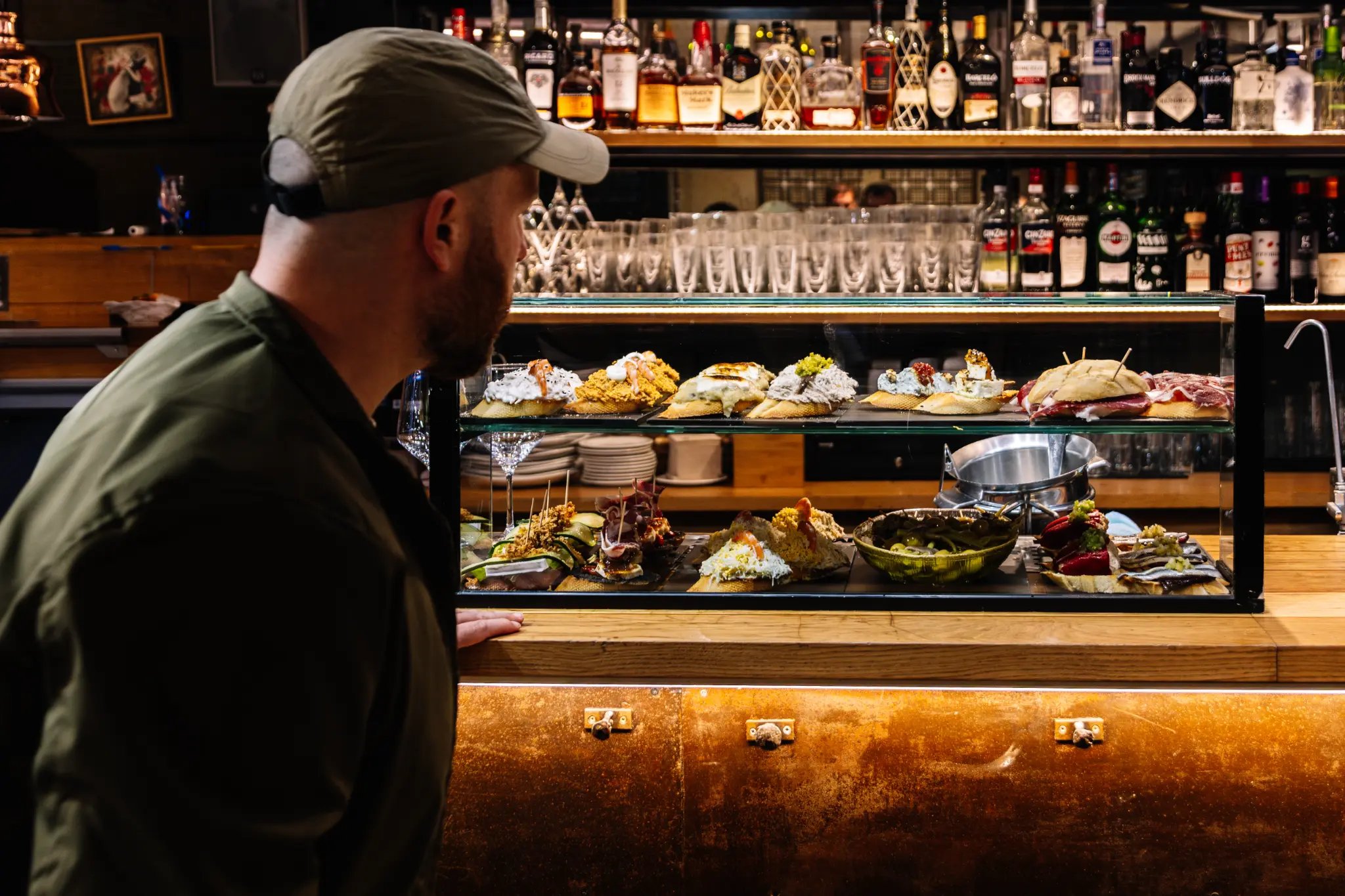 Pintxos and local produce on the counter at a San Sebastian market brunch tour